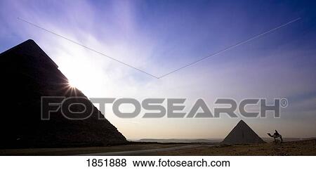 Two Of The Pyramids With A Traveller On A Camel Nearby; Cairo, Egypt, Africa View Large Photo Image Stock Photo - Two Of The Pyramids With A Traveller On A Camel Nearby; Cairo, Egypt, Africa. Fotosearch