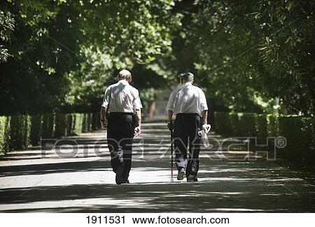 Two Old Men Walking In Park, Rear View, Royal Palace (Palacio Real), Aranjuez, Spain View Large Photo Image Stock Image - Two Old Men Walking In Park, Rear View, Royal Palace (Palacio Real), Aranjuez, Spain. Fotosearch