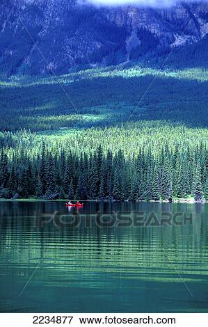 Stock Photo - Two People Canoeing Across Pyramid Lake, Jasper, Alberta, Canada.. Fotosearch