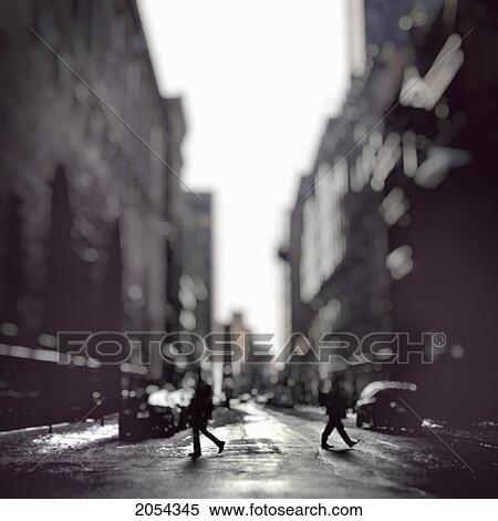 Stock Photography - Two People Crossing A City Street In Opposite Directions, Montreal, Qc. Fotosearch