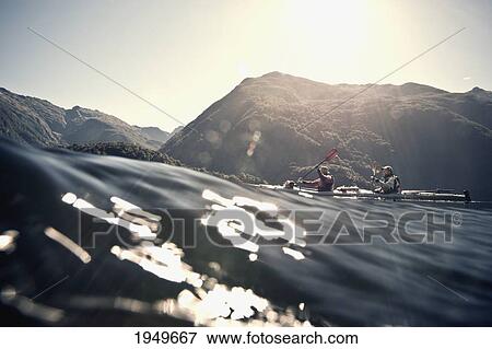 Two People Kayaking In Doubtful Sound; Manapouri South Island New Zealand View Large Photo Image Stock Photo - Two People Kayaking In Doubtful Sound; Manapouri South Island New Zealand. Fotosearch
