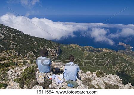 Two People Looking At Coastline From Mountain Top, Rear View, Majorca, Balearic Islands, Spain View Large Photo Image Picture - Two People Looking At Coastline From Mountain Top, Rear View, Majorca, Balearic Islands, Spain. Fotosearch