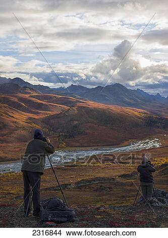 Picture - Two People Photographing The Colors Of Autumn Over Klondike Valley In Tombstone Territorial Park; Yukon Canada. Fotosearch