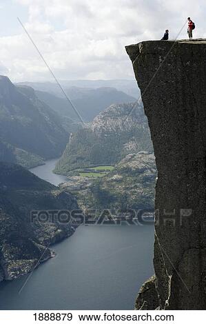 Stock Photo - Two People Standing On Edge Of Pulpit Rock. Fotosearch