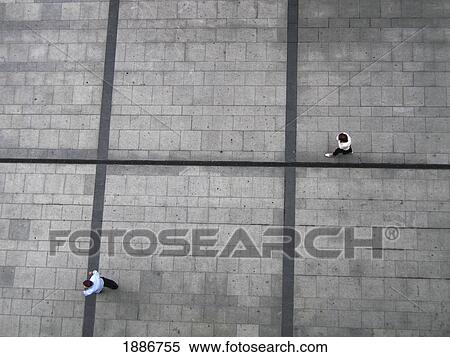 Stock Photography - Two People Walking On Pavement, Aerial View. Fotosearch