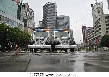 Two Police Trucks Parked On The Wet Street; Kunming Yunnan China View Large Photo Image Stock Photography - Two Police Trucks Parked On The Wet Street; Kunming Yunnan China. Fotosearch