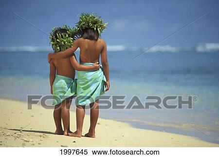 Stock Photography - Two Polynesian Girls Pareo And Haku Leis Face Water, Arms Around Each Other, Behind. Fotosearch