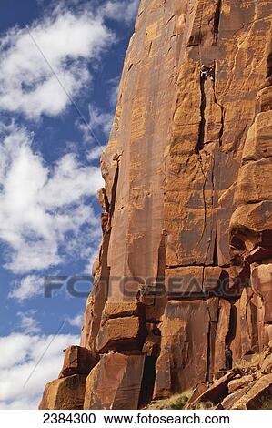 Stock Image - Two rock climbers on their ascent of Sugar On My Tongue 5. 11+, Hart's Draw; Utah, United States. Fotosearch