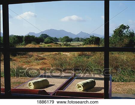 Stock Photo - Two Sunloungers And Rural Landscape As Seen From A Window. Fotosearch