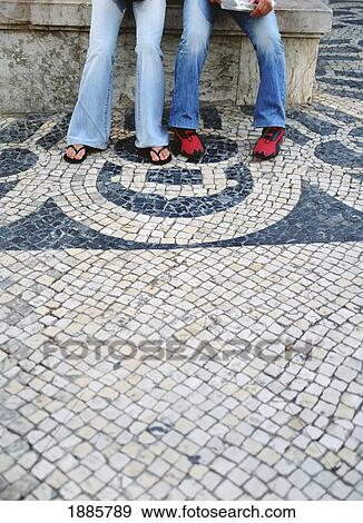 Stock Photo - Two Teenagers Sitting On A Beach, Tiles In Foreground. Fotosearch
