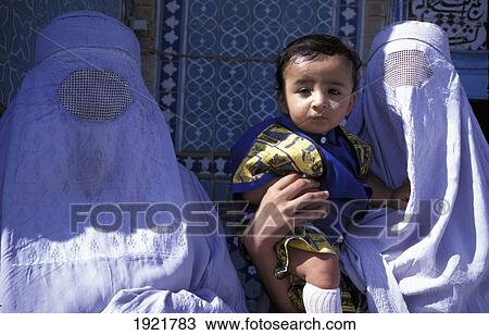 Stock Image - Two Veiled Women With Child; Samarkand, Uzbekistan. Fotosearch