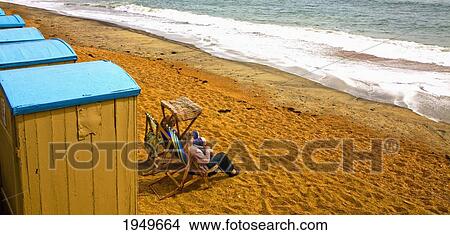 Picture - Two Woman Sitting At The Beach Enjoying The Sun; Ventnor Isle Of Wight England. Fotosearch