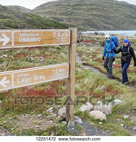 Stock Image - Two women hiking in Torres del Paine National Park; Torres del Paine, Magallanes and Antartica Chilena Region, Chile. Fotosearch