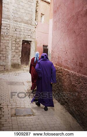 Stock Photo - Two Women In Traditional Dress Waliking Through Medina, Marrakesh, Morocco. Fotosearch