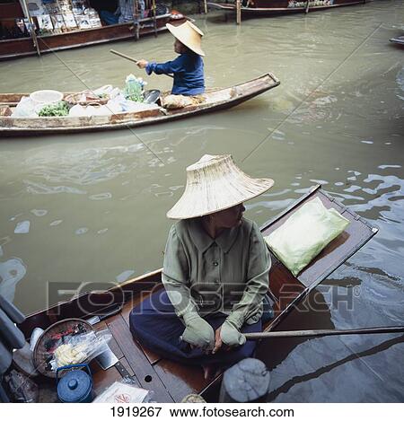 Stock Photo - Two Women On Boats At Floating Market. Fotosearch