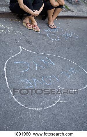 Two Women Sitting On Curb By Chalk Drawing, Low Section View Large Photo Image Stock Image - Two Women Sitting On Curb By Chalk Drawing, Low Section. Fotosearch