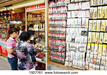 Two Women Standing In Front Of Shop Window, Guangzhou, China View Large Photo Image Stock Image - Two Women Standing In Front Of Shop Window, Guangzhou, China. Fotosearch