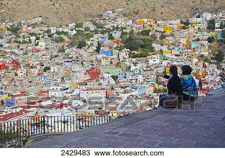 Stock Image - Two women viewing the cityscape of Guanajuato; Guanajuato, Mexico. Fotosearch