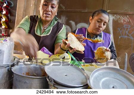 Two women working at a food stand making gorditas; San Luis de la Paz, Guanajuato, Mexico View Large Photo Image Picture - Two women working at a food stand making gorditas; San Luis de la Paz, Guanajuato, Mexico. Fotosearch