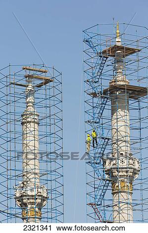 Two workers on scaffolding surrounding minarets of Ortakoy mosque which are under renovation; Istanbul, Istanbul Province, Turkey View Large Photo Image Stock Image - Two workers on scaffolding surrounding minarets of Ortakoy mosque which are under renovation; Istanbul, Istanbul Province, Turkey. Fotosearch