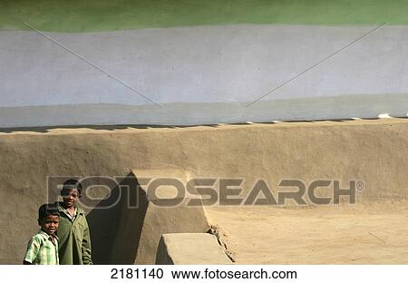 Two young boys stand outside a building painted green and white; Madhya Pradesh, India View Large Photo Image Stock Image - Two young boys stand outside a building painted green and white; Madhya Pradesh, India. Fotosearch
