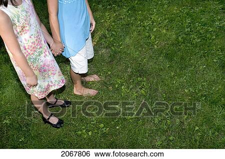 Two Young Girls Holding Hands Outside View Large Photo Image Stock Photograph - Two Young Girls Holding Hands Outside. Fotosearch