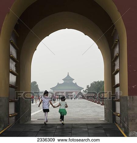 Two Young Girls Walking Through An Archway At The Temple Of Heaven; Beijing, China View Large Photo Image Stock Photo - Two Young Girls Walking Through An Archway At The Temple Of Heaven; Beijing, China. Fotosearch