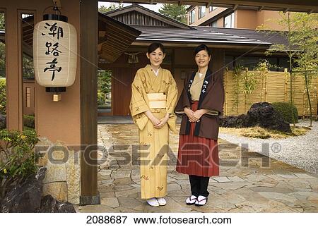 Stock Photo - Two Young Japanese Ladies Wearing Kimonos Posing Under A Gate With A White Paper Lantern; Toba Mie Japan. Fotosearch