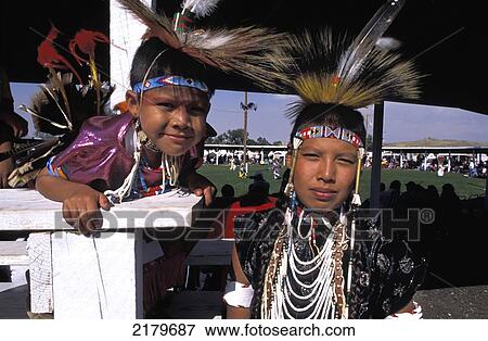 Stock Photo - Two young male Crow Indians in traditional robes to join the Pow-wow at annual Crow fair, Crow reservation; Montana, United States of America. Fotosearch