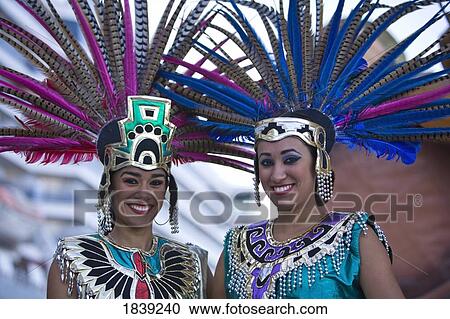 Two Young Women In Aztec Outfits, Wearing Feather Headdress With Pheasant Feathers, Cruise Ship Terminal; Mazatlan, Sinaloa, Mexico View Large Photo Image Stock Image - Two Young Women In Aztec Outfits, Wearing Feather Headdress With Pheasant Feathers, Cruise Ship Terminal; Mazatlan, Sinaloa, Mexico. Fotosearch