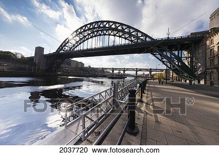 Stock Image - Tyne Bridge And The Promenade Beside River Tyne; Newcastle Northumberland England. Fotosearch