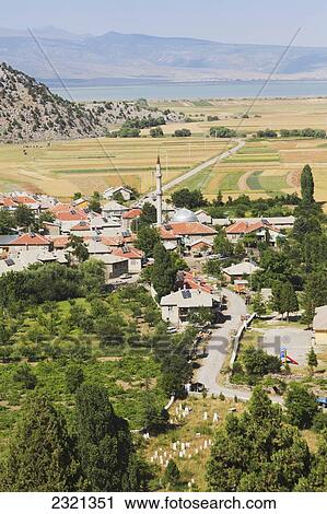 Stock Image - Typical Anatolian farming community with Lake Sugla in background; Susuz-Koyu, Konya Province, Turkey. Fotosearch