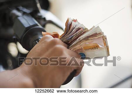 Stock Image - Typical Philippino way to carry the money for people working in shops, or tuk tuk drivers; Boracay, Panay, Philippines. Fotosearch