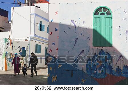 Stock Image - Typical Street Scene In Medina With Murals On Walls; Asilah Morocco. Fotosearch