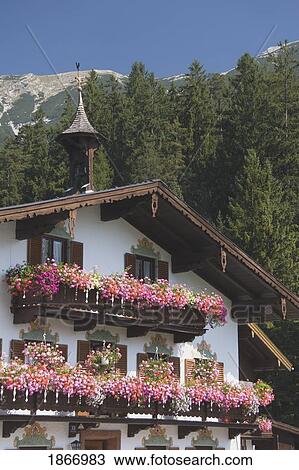 Stock Image - Tyrol, Austria; Tyrolean House With Flower Boxes. Fotosearch