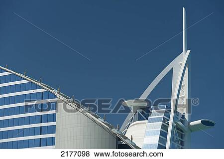 Stock Photo - UAE, Detail of Jumeirah Beach Hotel and Burj Al Arab Hotel; Dubai. Fotosearch