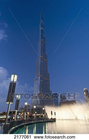 Stock Image - UAE, Fountain display in front of Burj Khalifa at dusk; Dubai. Fotosearch