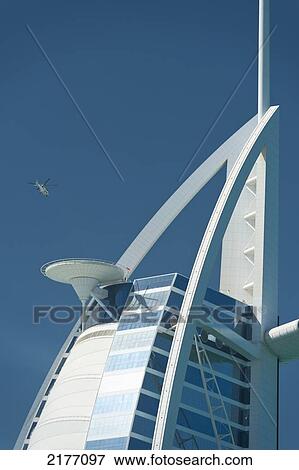 Stock Photo - UAE, Helicopter taking off from top of Burj Al Arab hotel; Dubai. Fotosearch