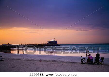 UAE, People watching sunset on Jumeirah Beach; Dubai View Large Photo Image Stock Photo - UAE, People watching sunset on Jumeirah Beach; Dubai. Fotosearch