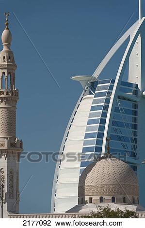 Stock Image - UAE, Small mosque in front of Burj Al Arab hotel; Dubai. Fotosearch