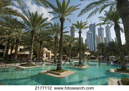 UAE, Swimming pool of the One and Only Royal Mirage with tower blocks behind; Dubai View Large Photo Image Stock Image - UAE, Swimming pool of the One and Only Royal Mirage with tower blocks behind; Dubai. Fotosearch