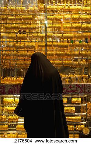 UAE, Woman looking in window of gold shop in the Gold Souk; Dubai View Large Photo Image Picture - UAE, Woman looking in window of gold shop in the Gold Souk; Dubai. Fotosearch