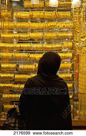 UAE, Woman looking in window of gold shop in Gold Souk; Dubai View Large Photo Image Stock Photo - UAE, Woman looking in window of gold shop in Gold Souk; Dubai. Fotosearch