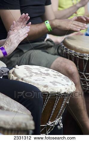 Stock Image - UK, Berkshire, details of hands; Reading, Djembe players. Fotosearch