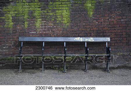 Stock Photograph - Uk, Brick Wall; London, Bench. Fotosearch