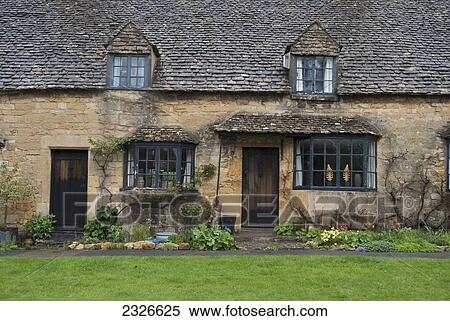 Uk Cotswolds Cottages On High Street Limestone Buildings Rainy