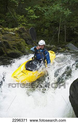 Stock Image - UK, Cumbria, Lake District National Park, Canoeist going down Skelwith Force waterfall; Langdale. Fotosearch
