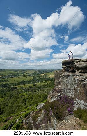 UK, Derbyshire, Mother and young girl sitting on rocks admiring view at Froggatt Edge across Peak District; Froggatt View Large Photo Image Stock Photo - UK, Derbyshire, Mother and young girl sitting on rocks admiring view at Froggatt Edge across Peak District; Froggatt. Fotosearch