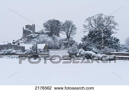 Stock Image - UK, East Sussex, Looking across bowling green to castle covered in snow; Lewes. Fotosearch