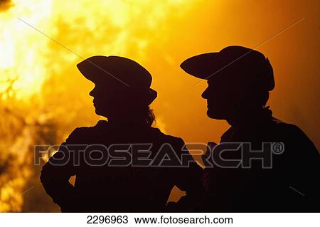 UK, East Sussex, Silhouettes of man and woman dressed as pirates in front of large bonfire; Lewes View Large Photo Image Stock Image - UK, East Sussex, Silhouettes of man and woman dressed as pirates in front of large bonfire; Lewes. Fotosearch
